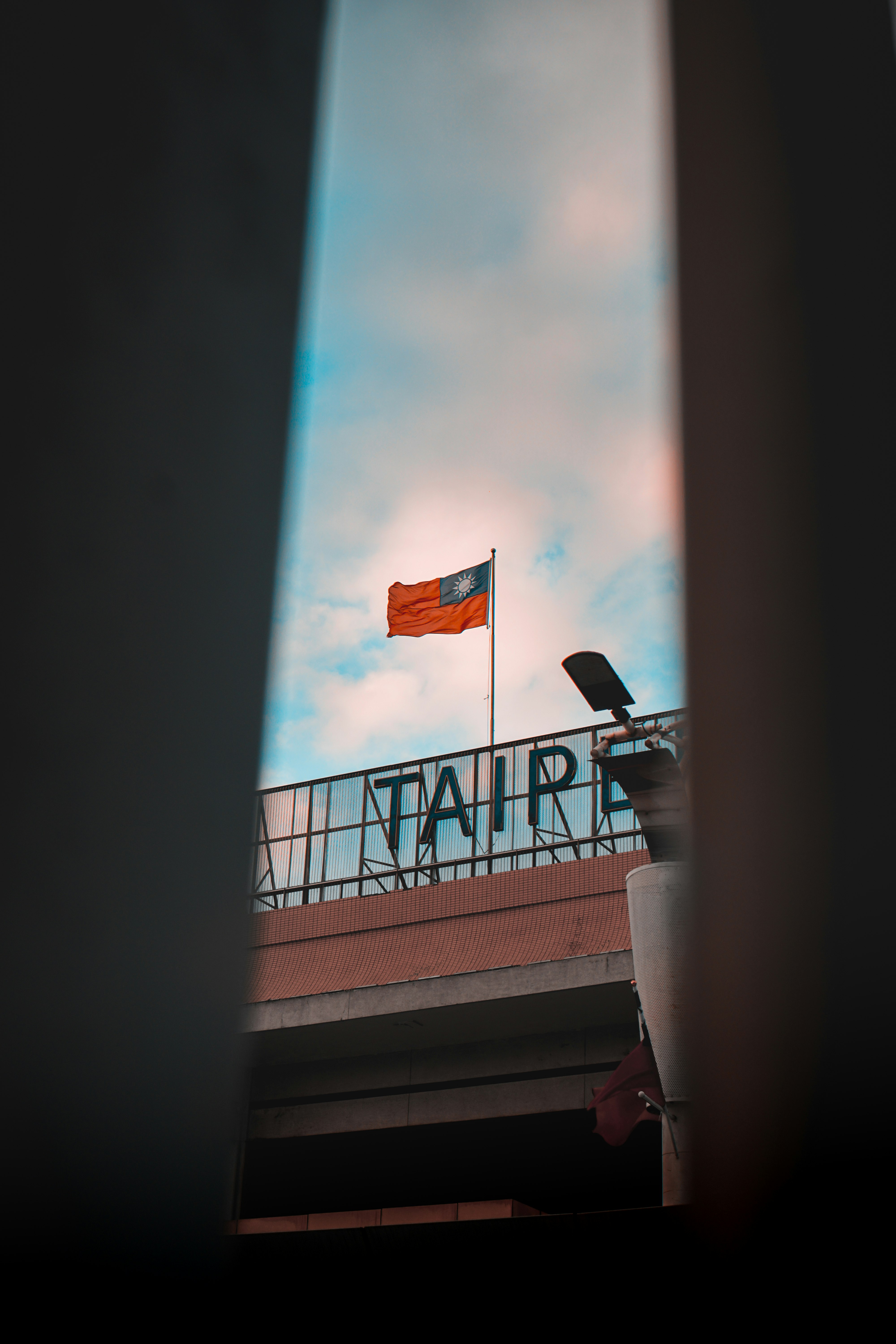orange and yellow flag on top of building